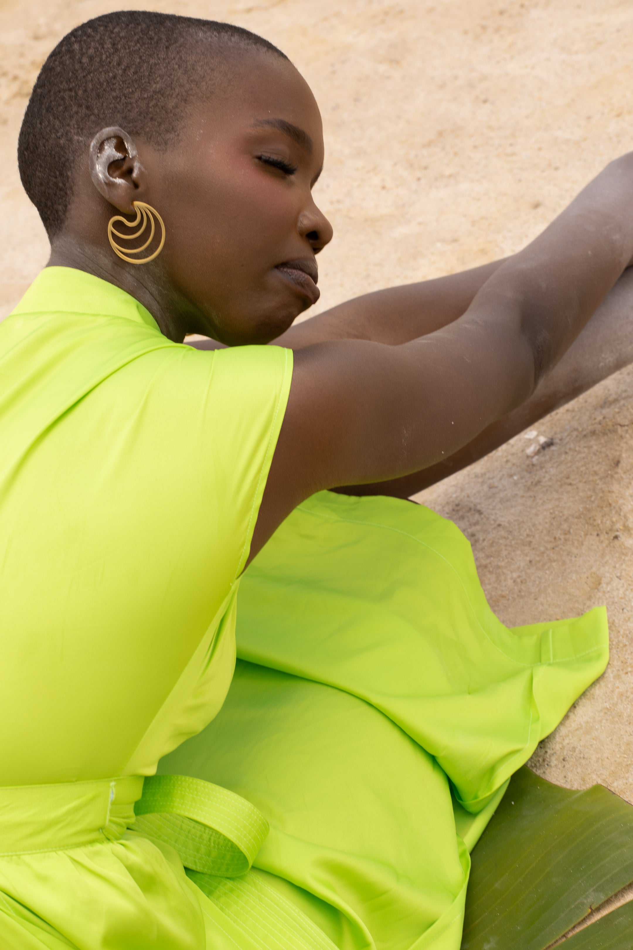 A model wearing a Zvet gold plated earrings