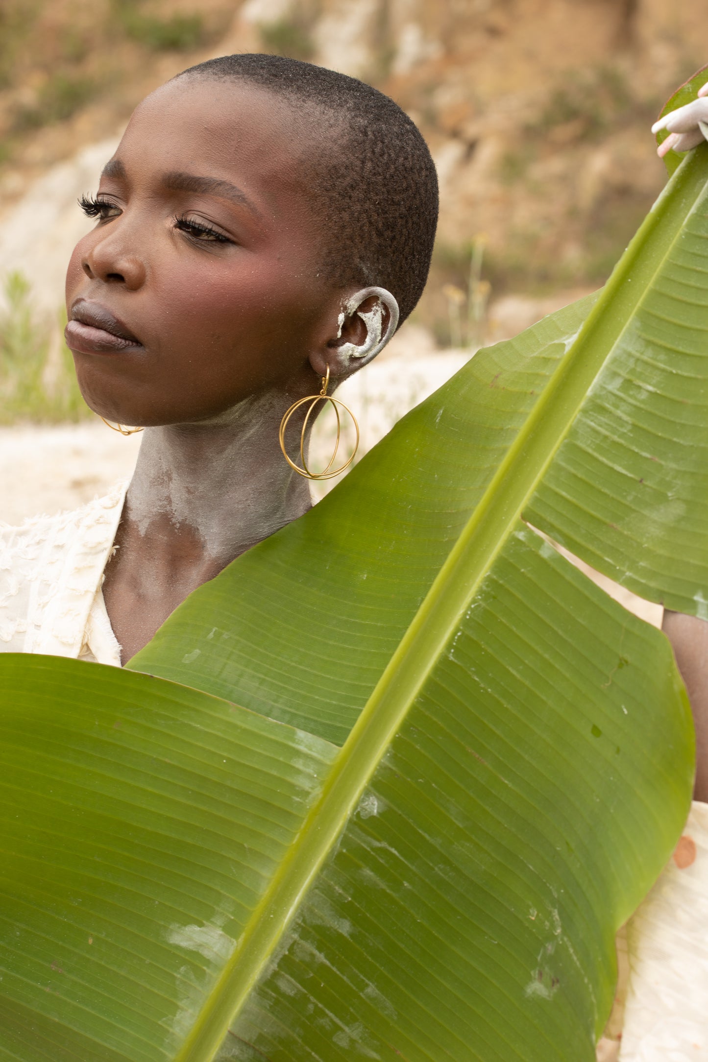 Model wearing nana earrings,gold plated hoops earrings intertwined