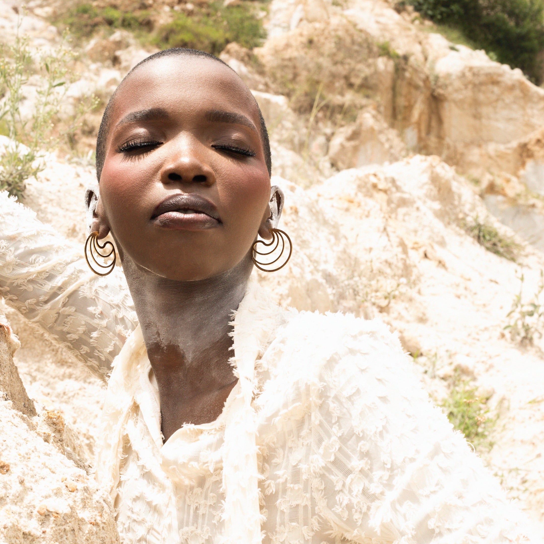 Model wearing luna stud earrings,gold plated stud earrings shaoed like a moon