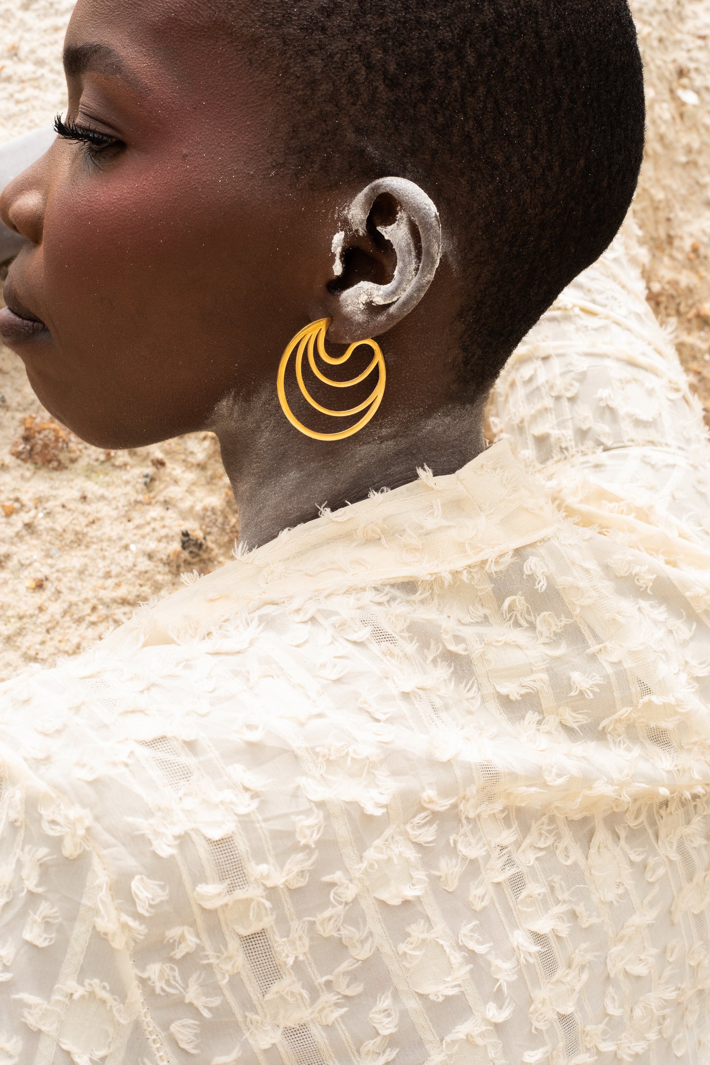 Model wearing luna stud earrings,gold plated stud earrings shaoed like a moon