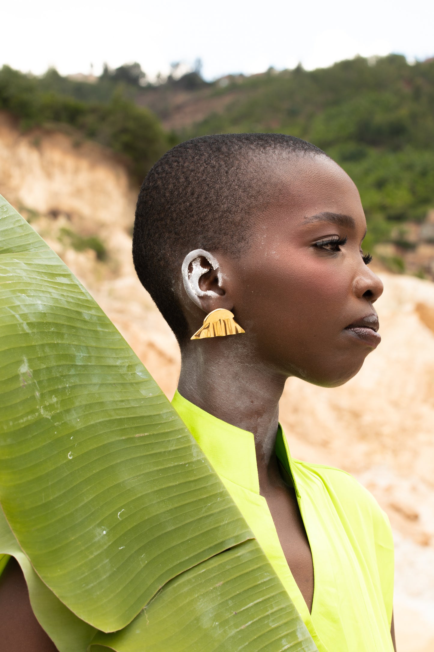 Model wearing a stud  gold plated earrings