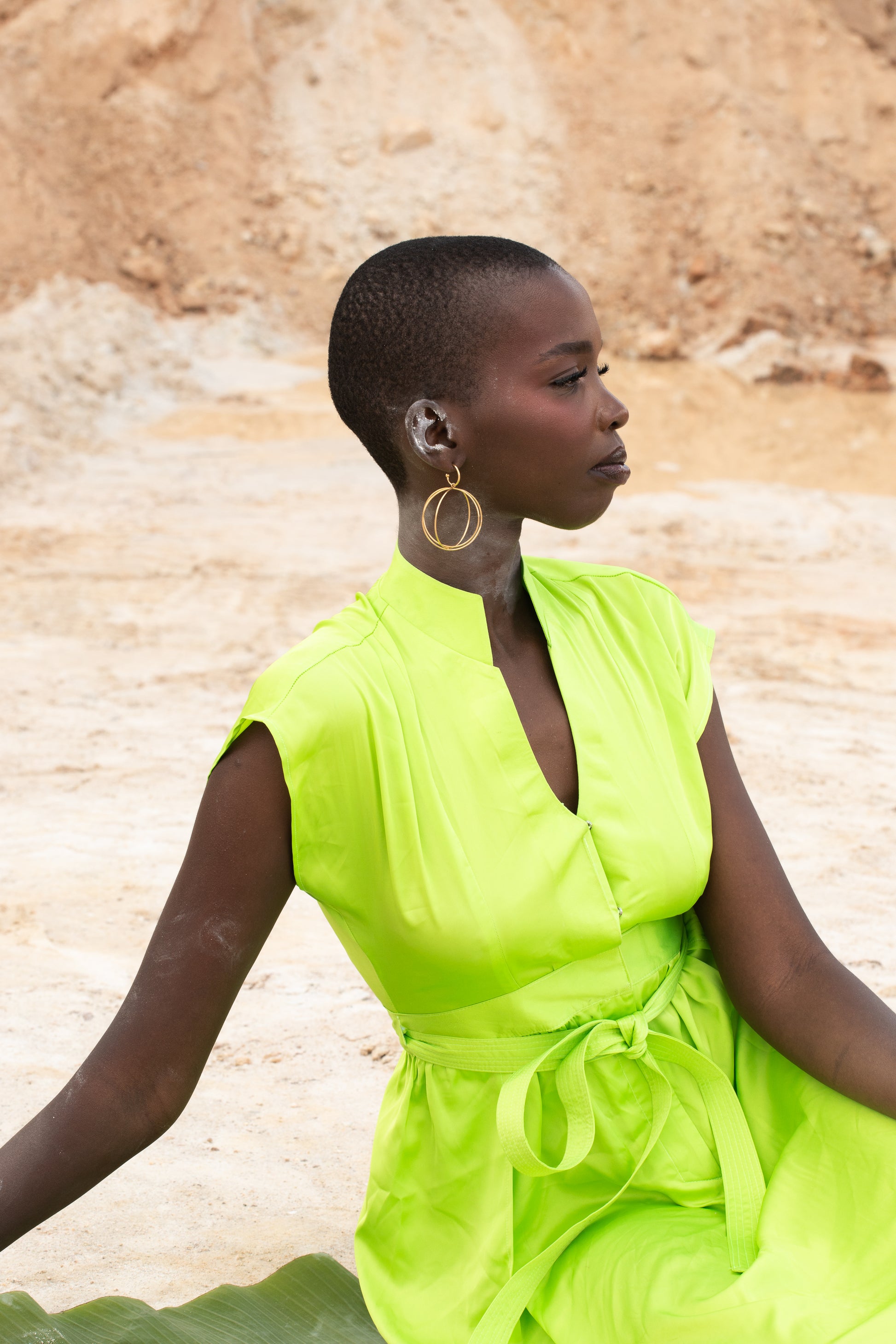 A black model wearing Zvet gold plated intertwined hoops symbolising ubuntu phiylosophy